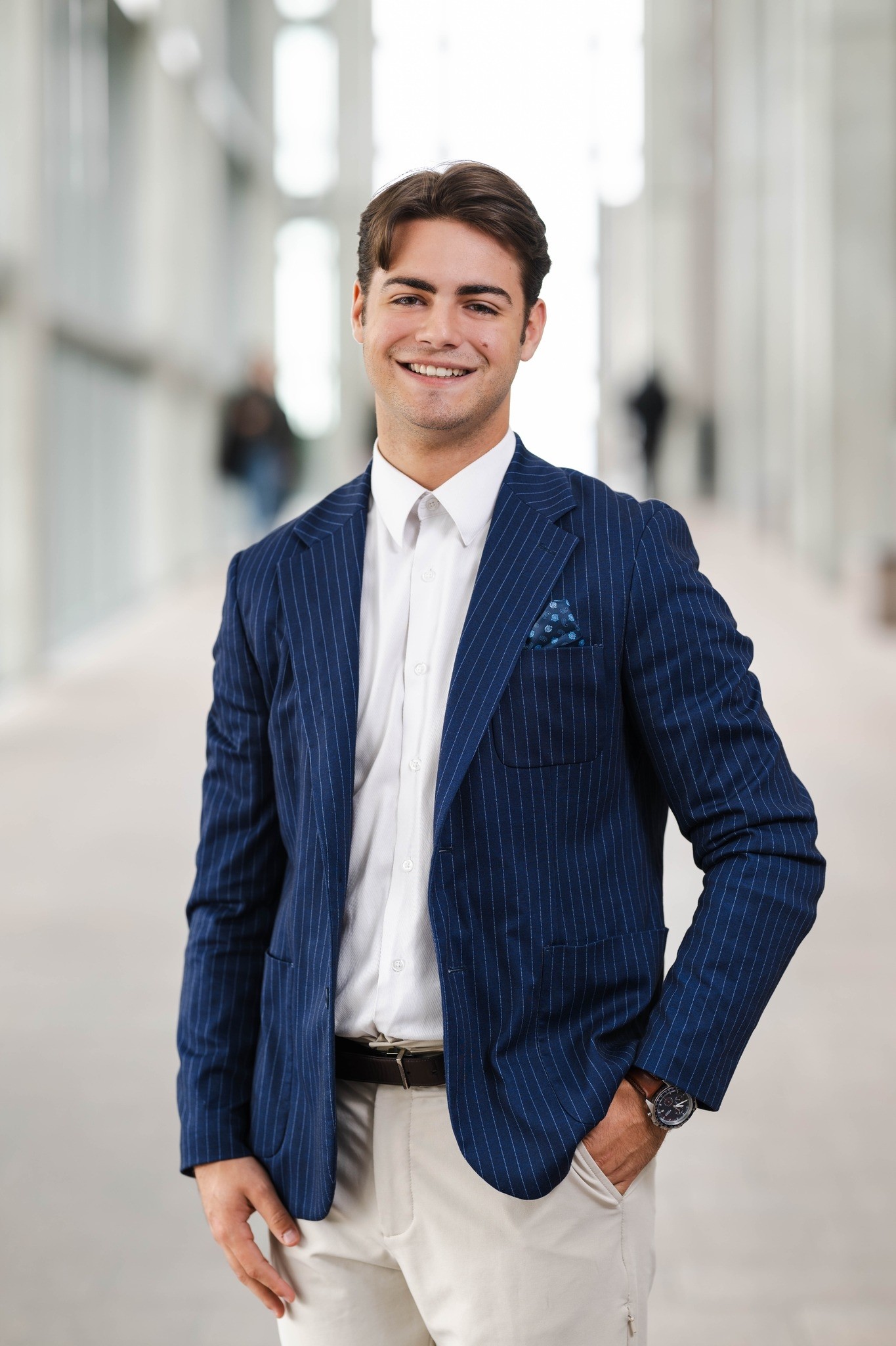 Young man in a suit smiling at the camera