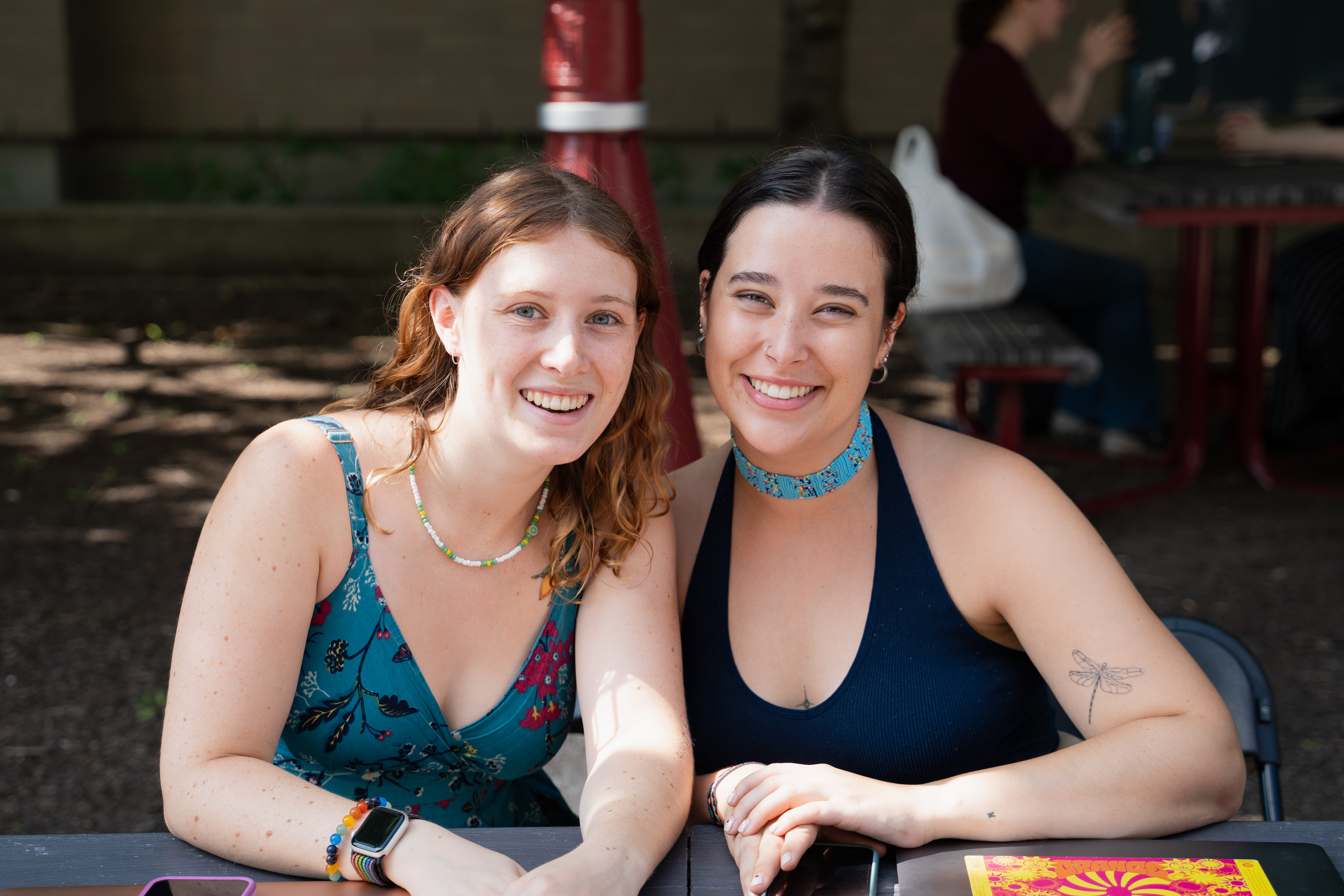 Two students smiling towards the camera.