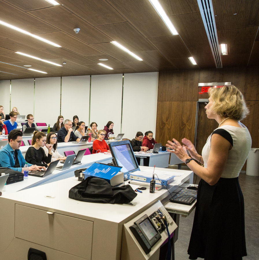 Lecturer teaching at the front of classroom