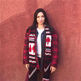 juliana_tpln in front of a terra cotta wall wearing a sash with canadian flags on her shoulders