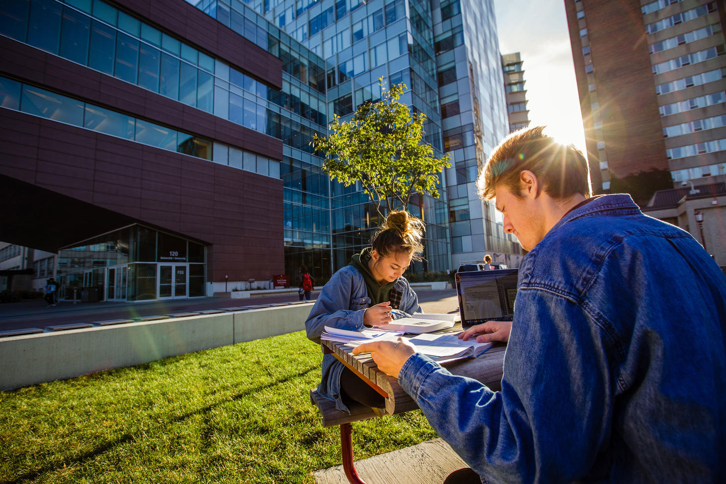 Students studying at picnic table on campus.