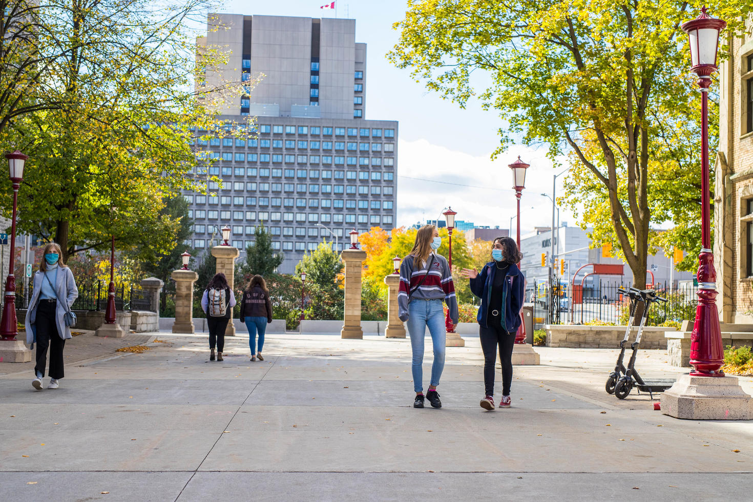 students wearing masks walking on campus