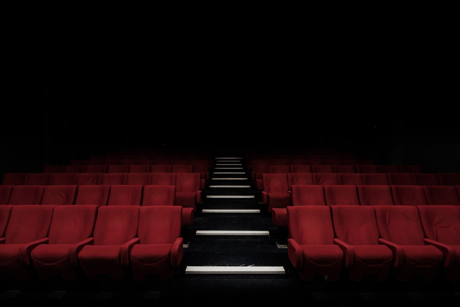 Rows of red seats in an auditorium