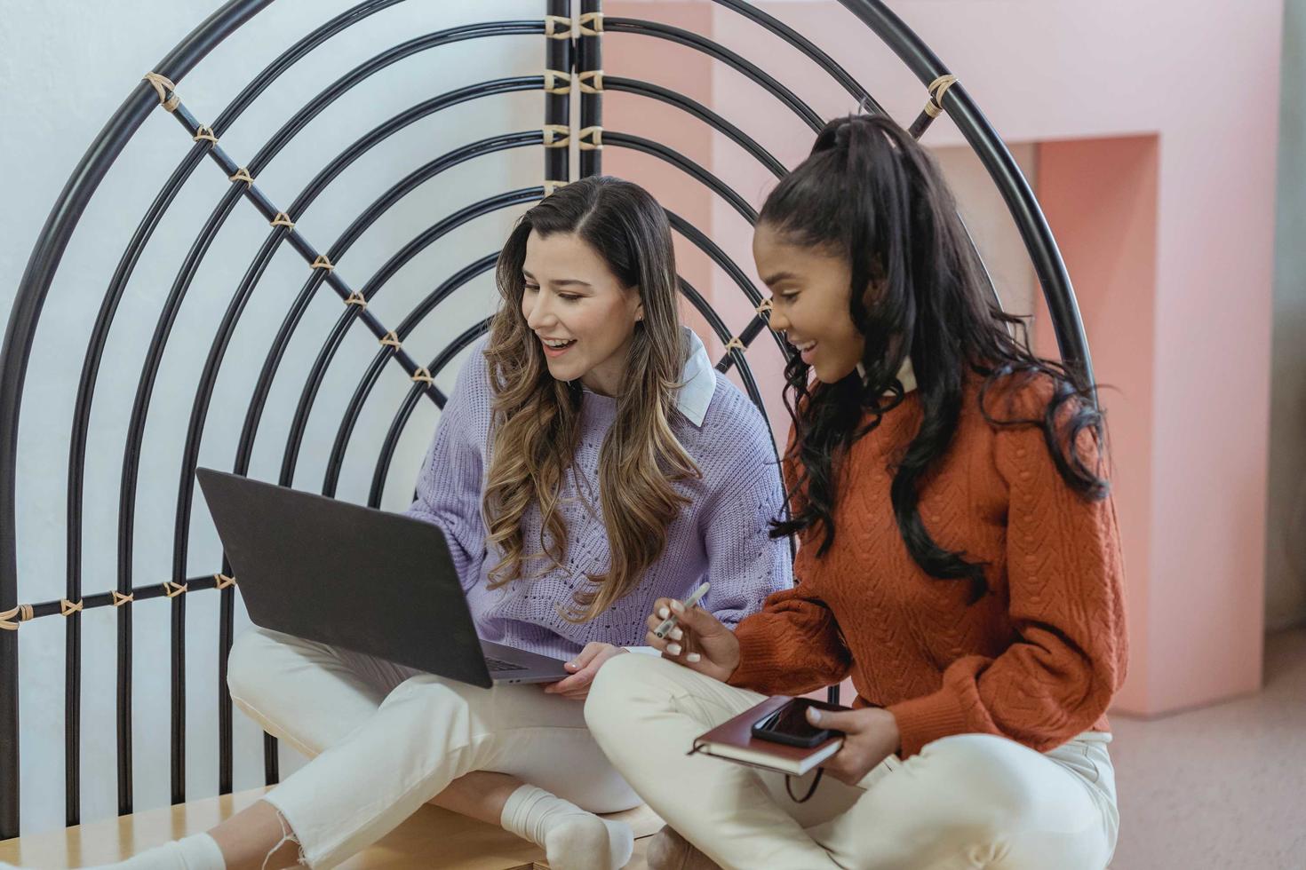 students smiling looking at laptop