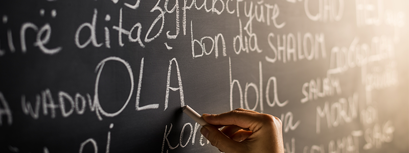 student writing spanish on blackboard