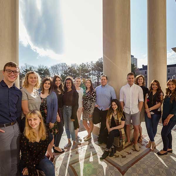 Group of student mentors next to Tabaret columns