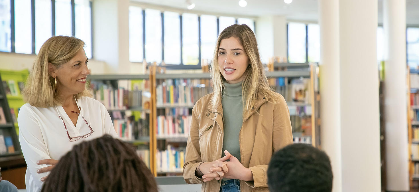 student talking to group