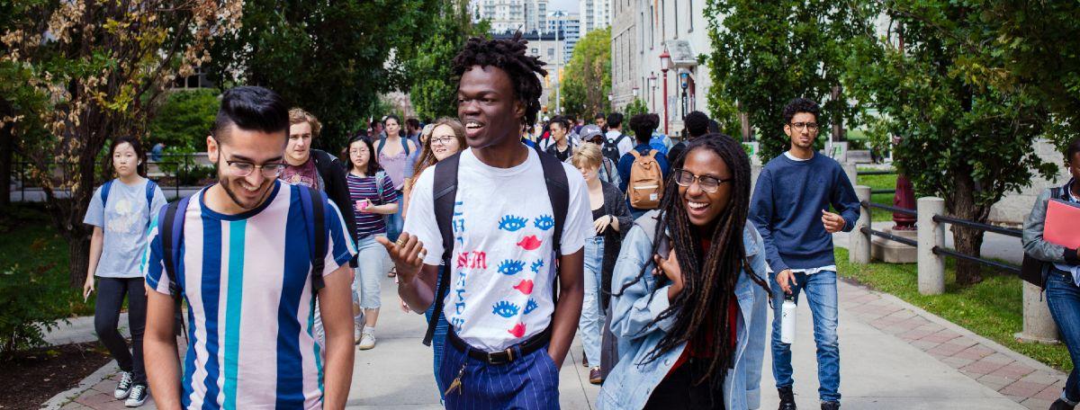 Students walking and laughing together on campus