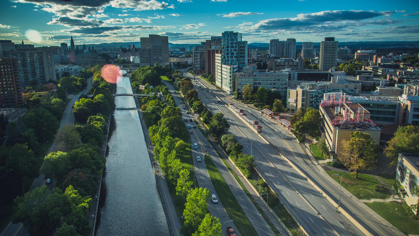 Aerial view of the Rideau Canal with the Ottawa skyline in the background.