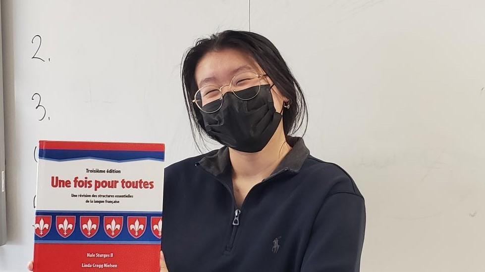 student holding a book