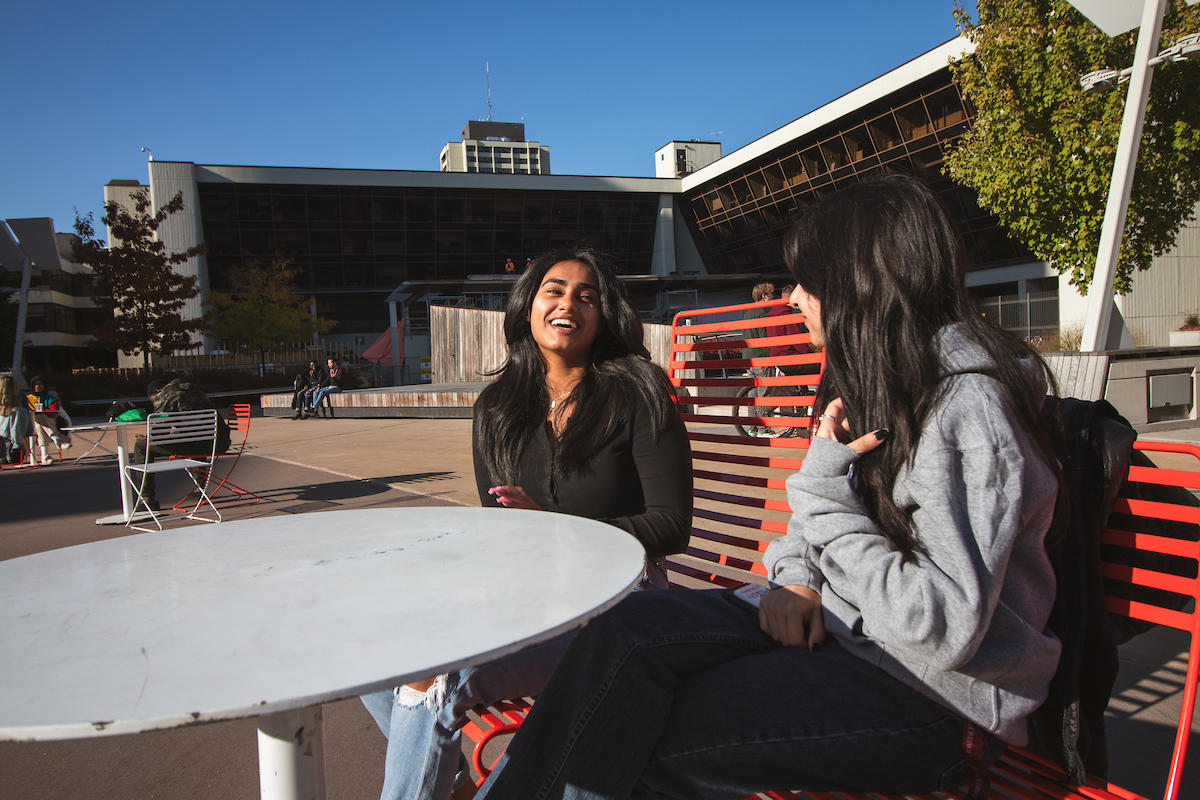 Students chatting outside on campus.