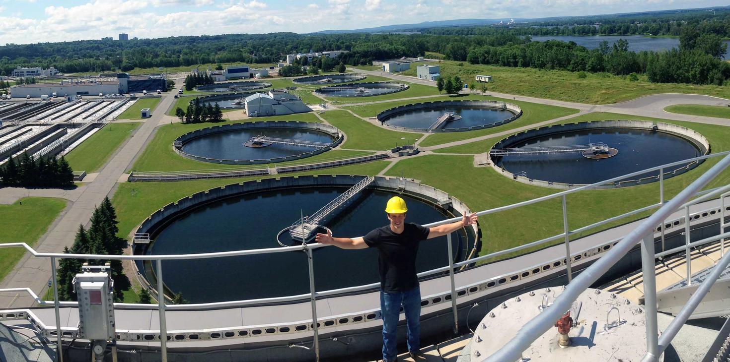 CO-OP student in front of reservoirs