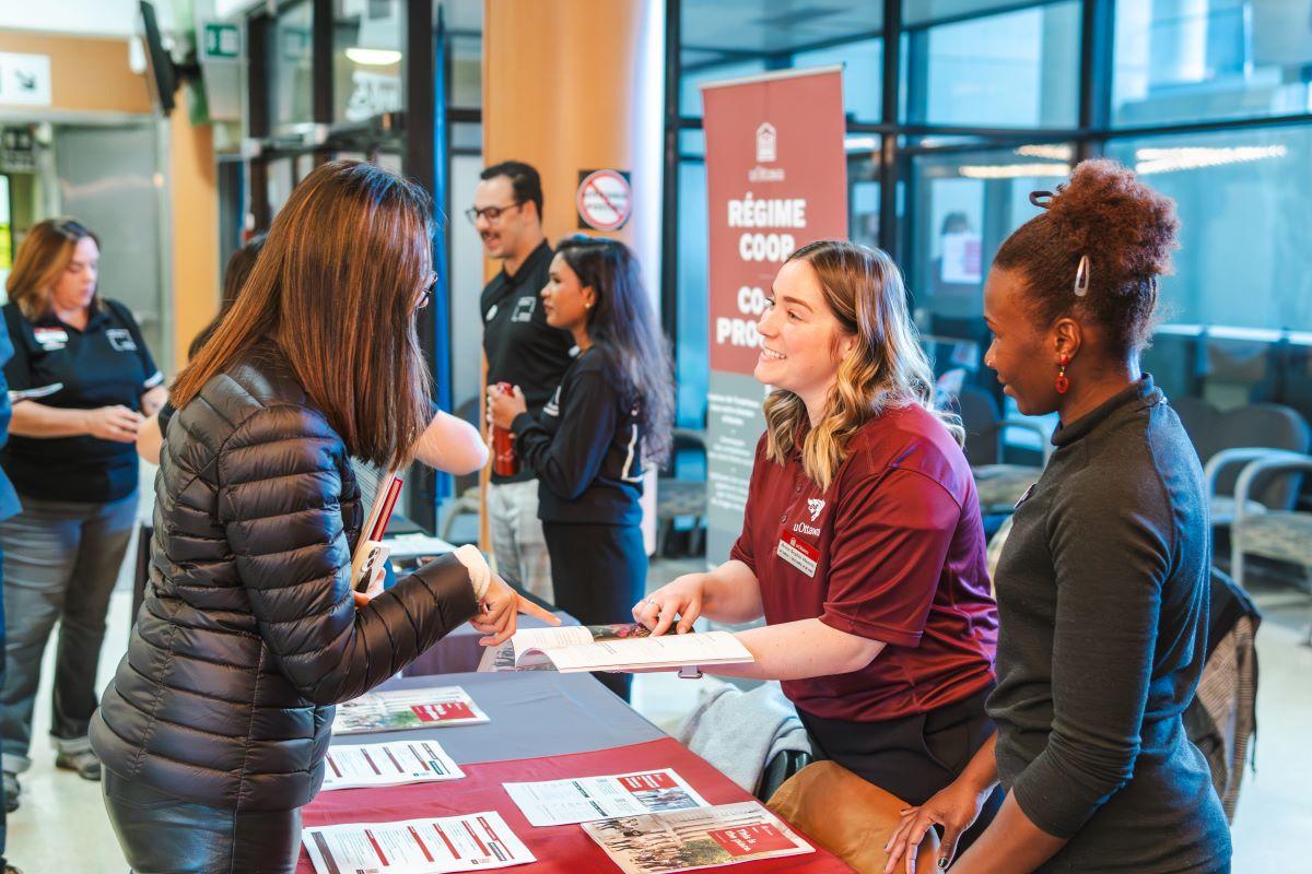 Career fair with students at an information kiosk