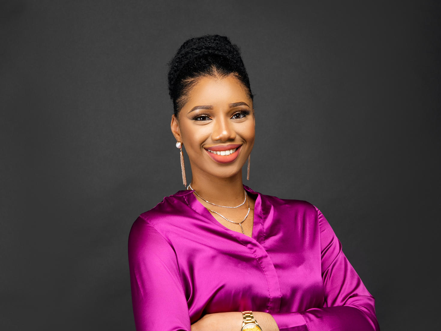 A professional picture of a woman smiling, set against a plain backdrop.