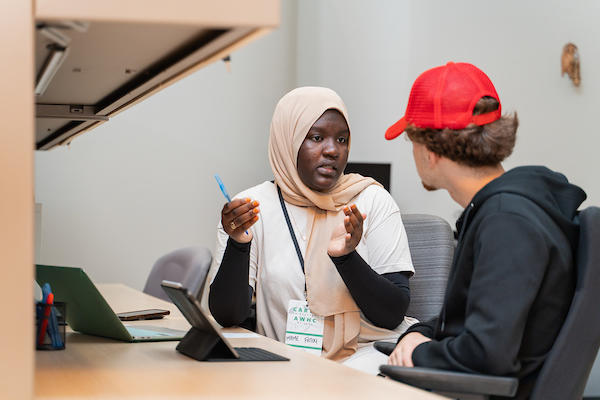 students chatting in front of computer