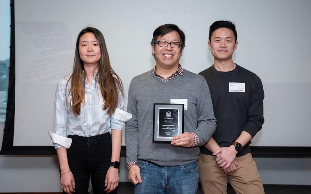 Recipient of the Employer of the Year Award with students and plaque