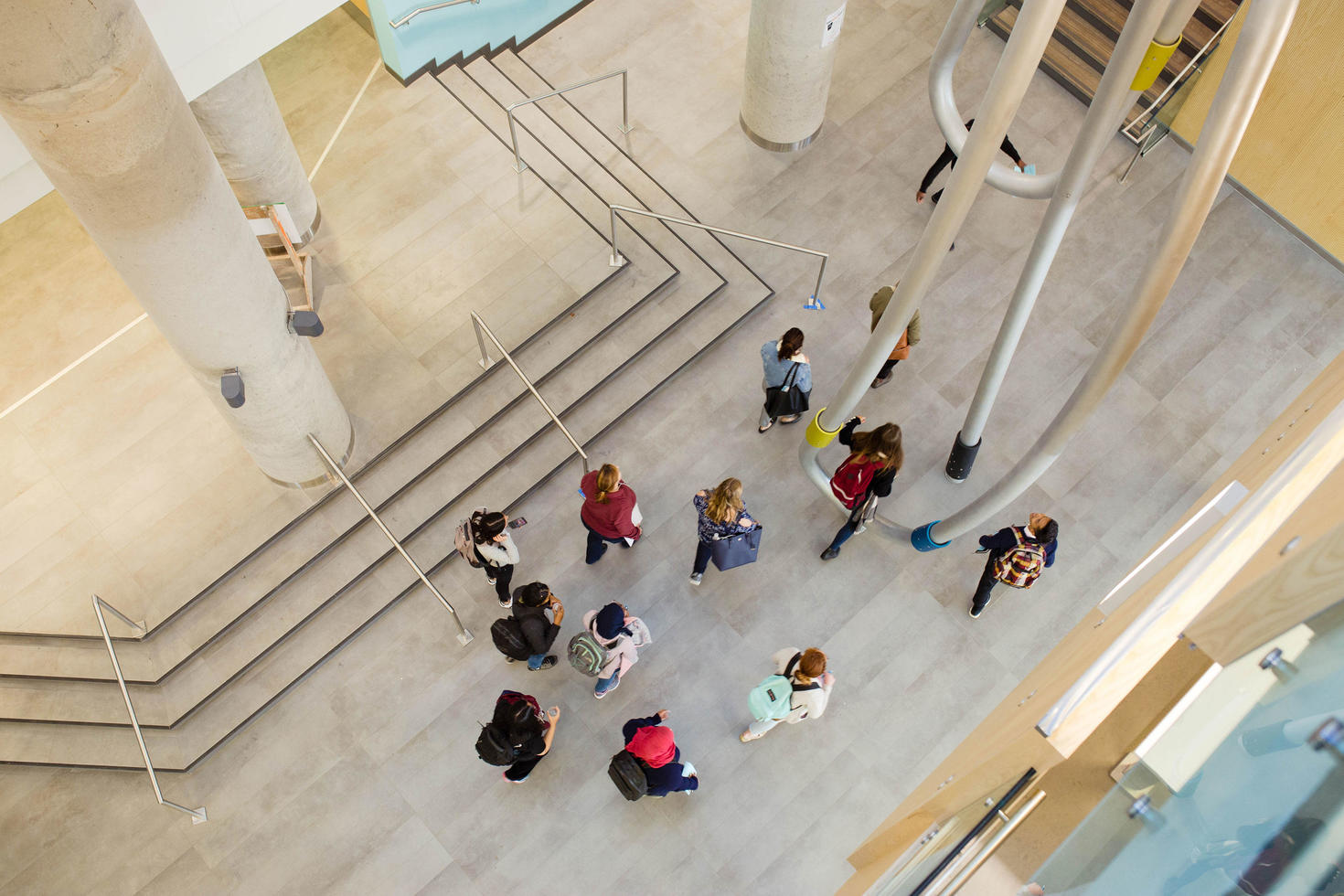 bird's eye view of students walking in a building