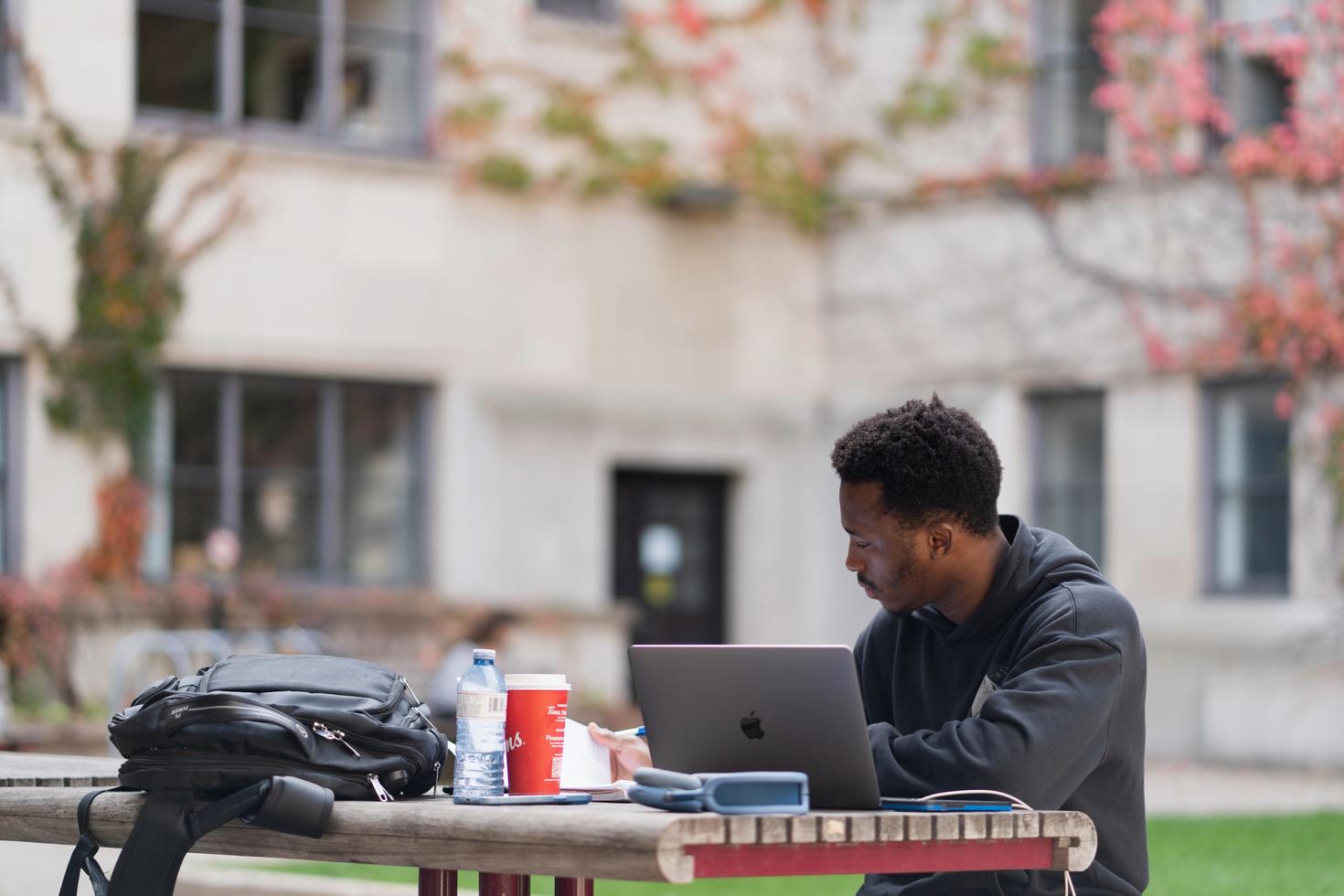 Student on table outside studying