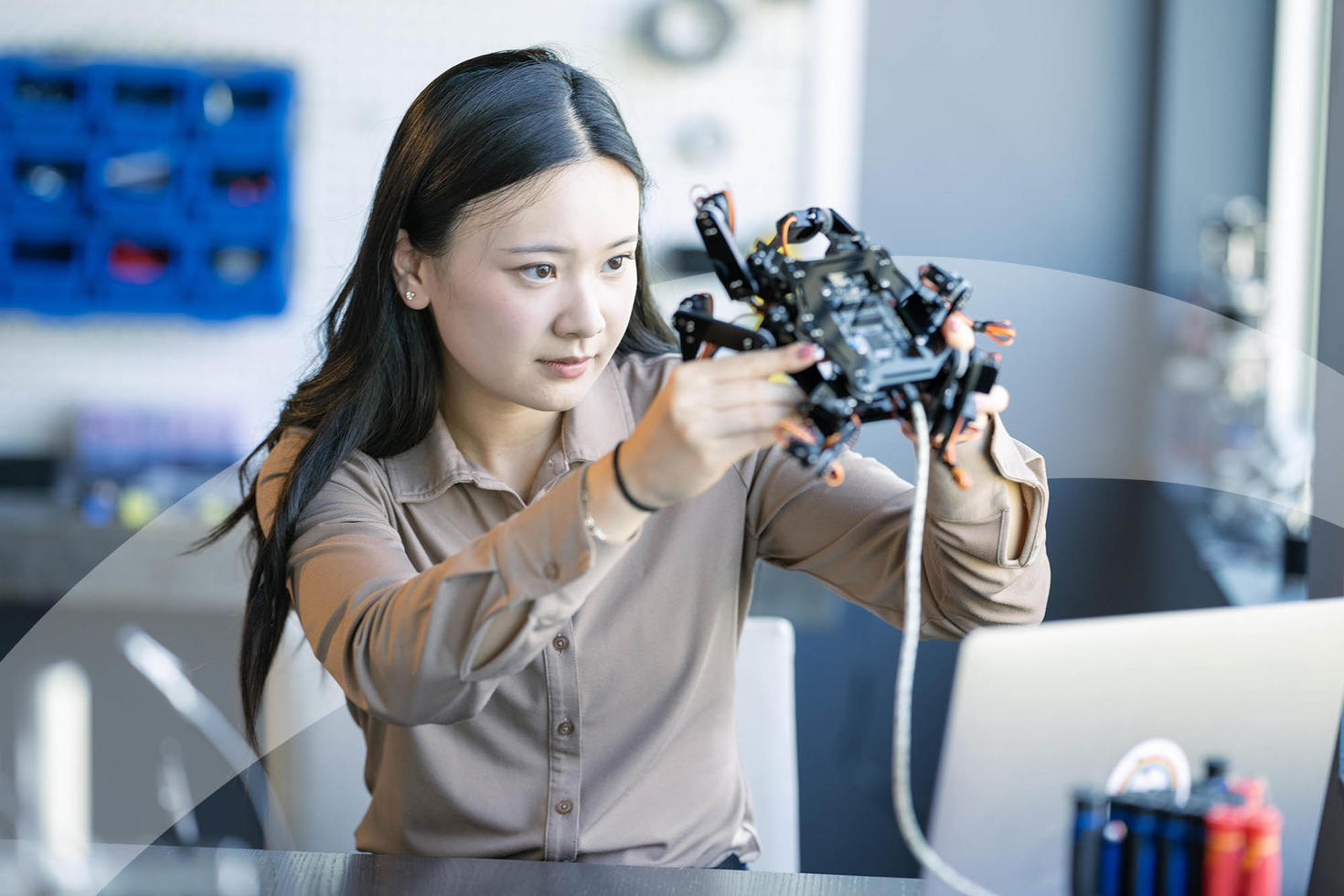 Student working in a lab with Open Minds branding