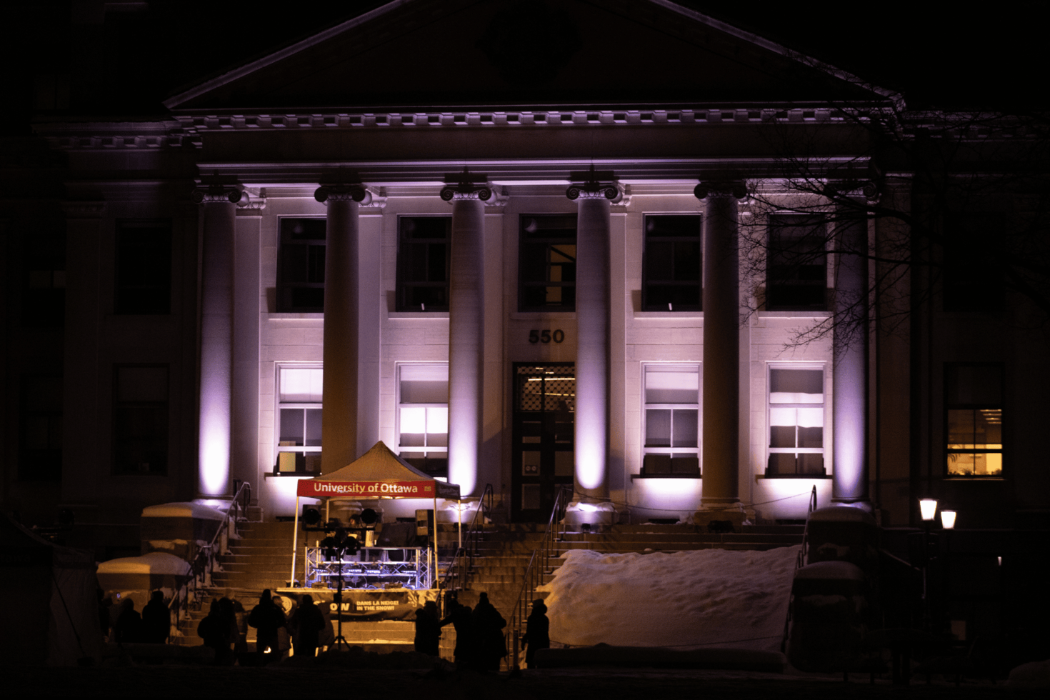 Front view of Tabaret Hall at night.