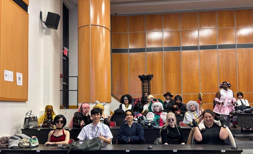 Members of the uoAnime student club in various costumes inside a classroom.