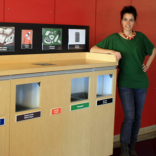 an employee stands beside a recycling station at uOttawa