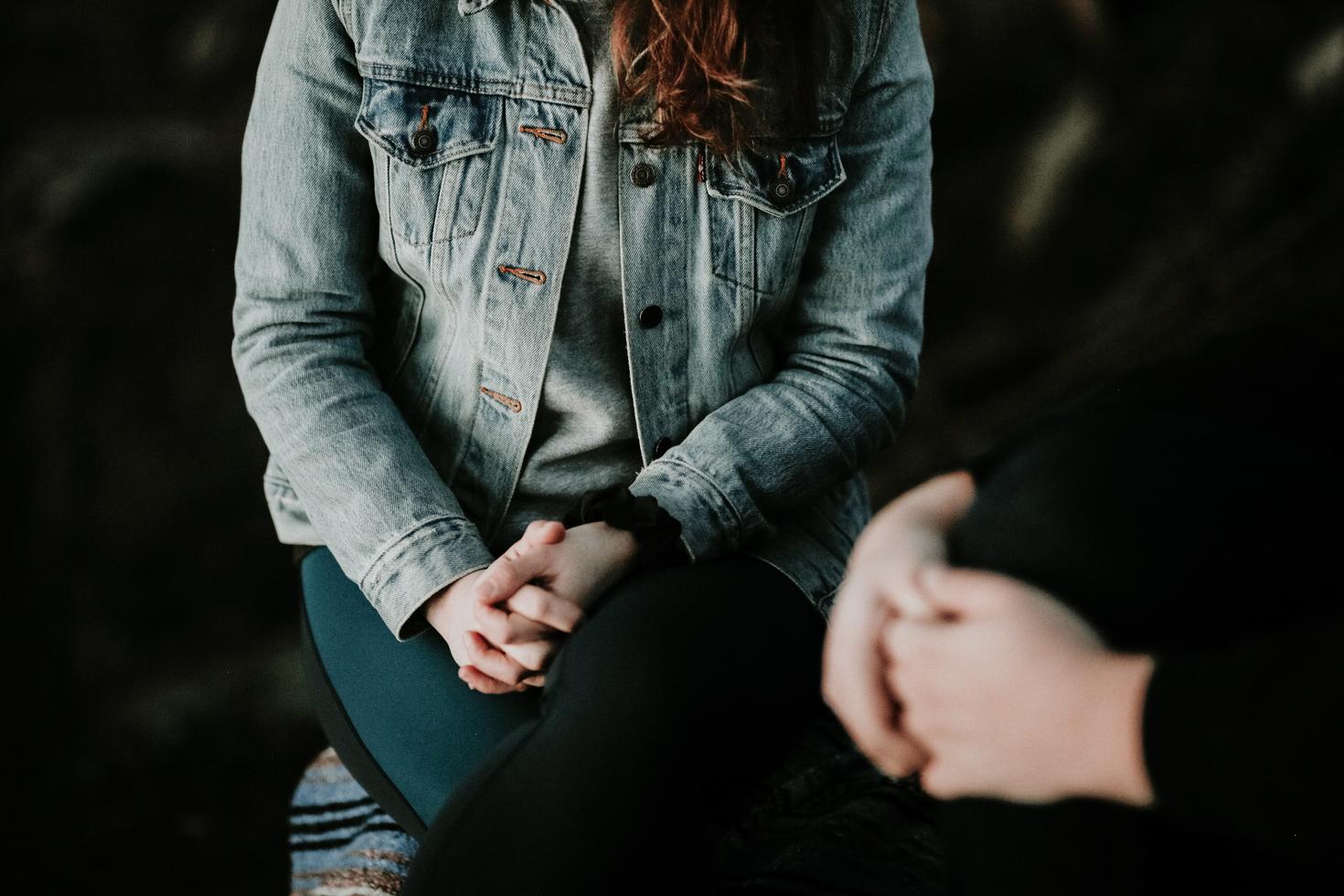 Two people sit across from each other