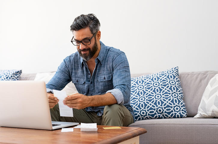 A man looking at receipts
