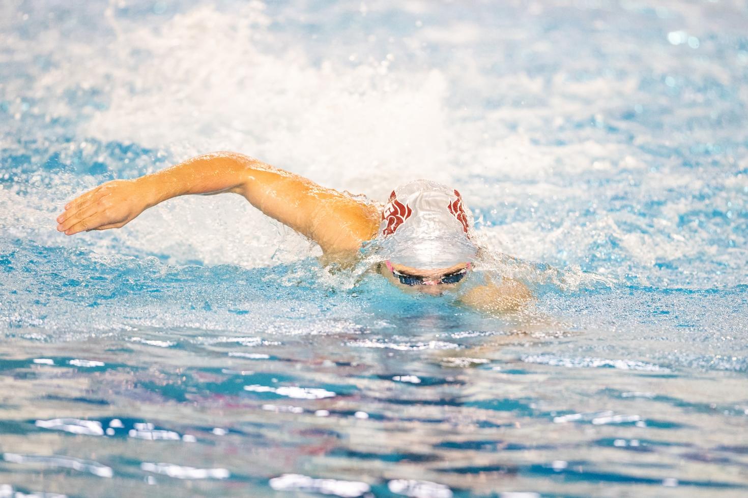 person swimming with gee-gees cap
