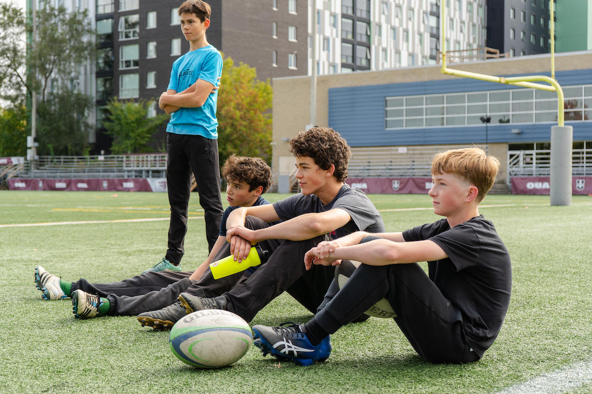 rugby kids sitting on field