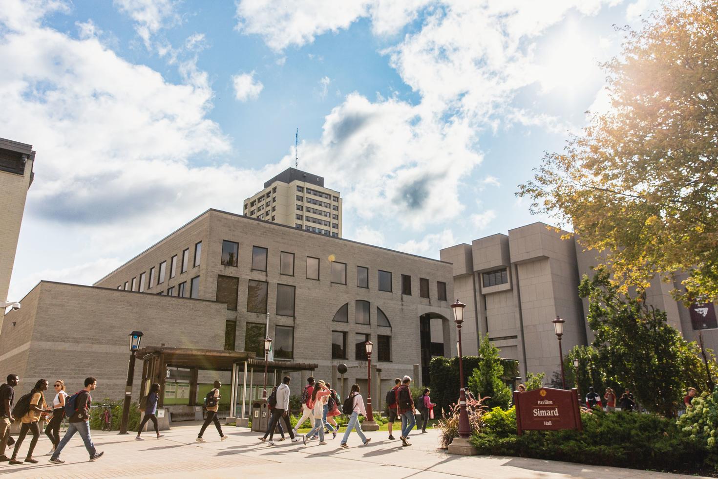 Arts Students walking near Simard Hall