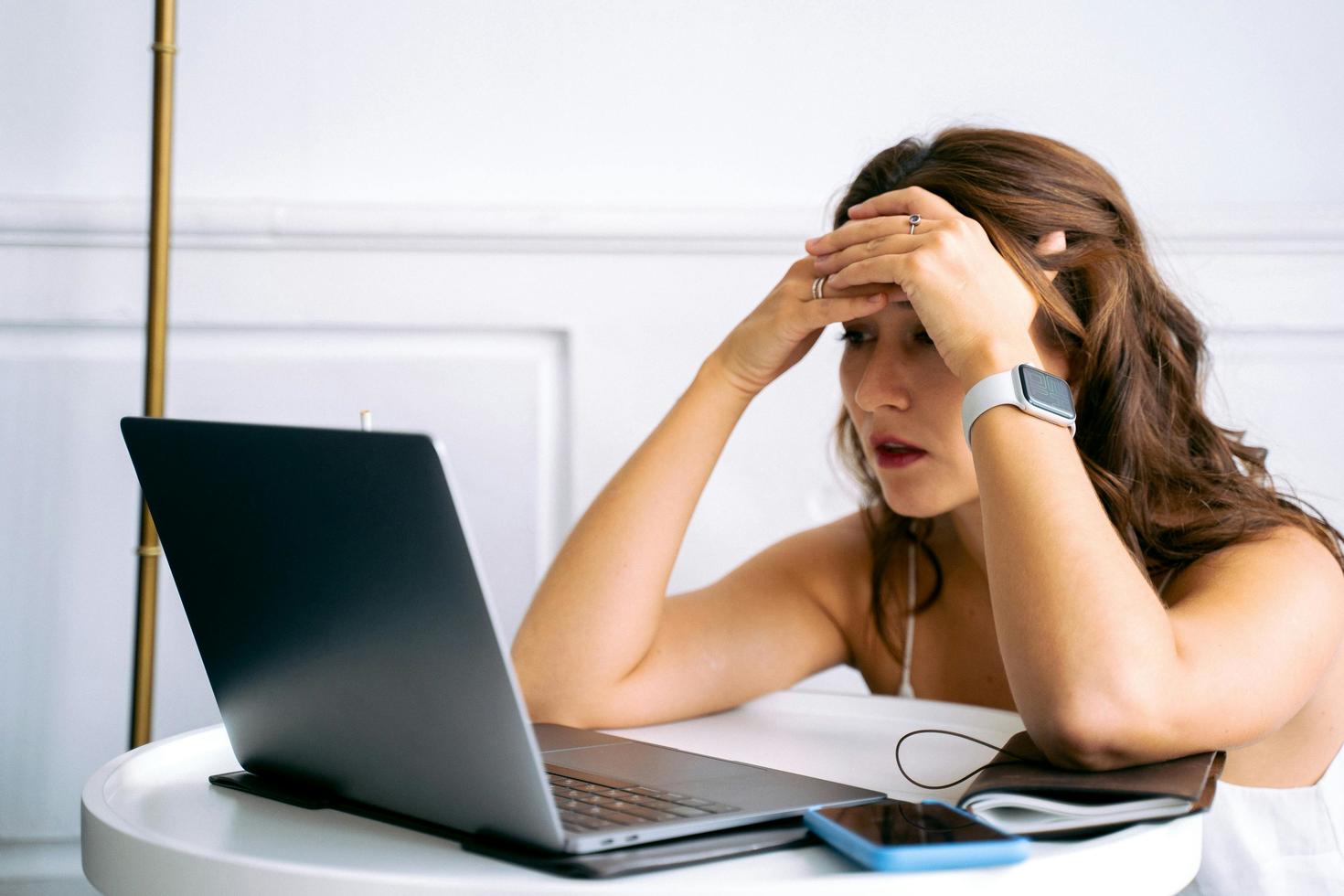 person looking at their computer in frustration